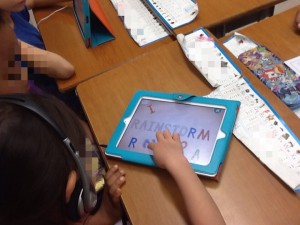 A student spelling the word "Rainstorm" using the Endless ABCs app.
